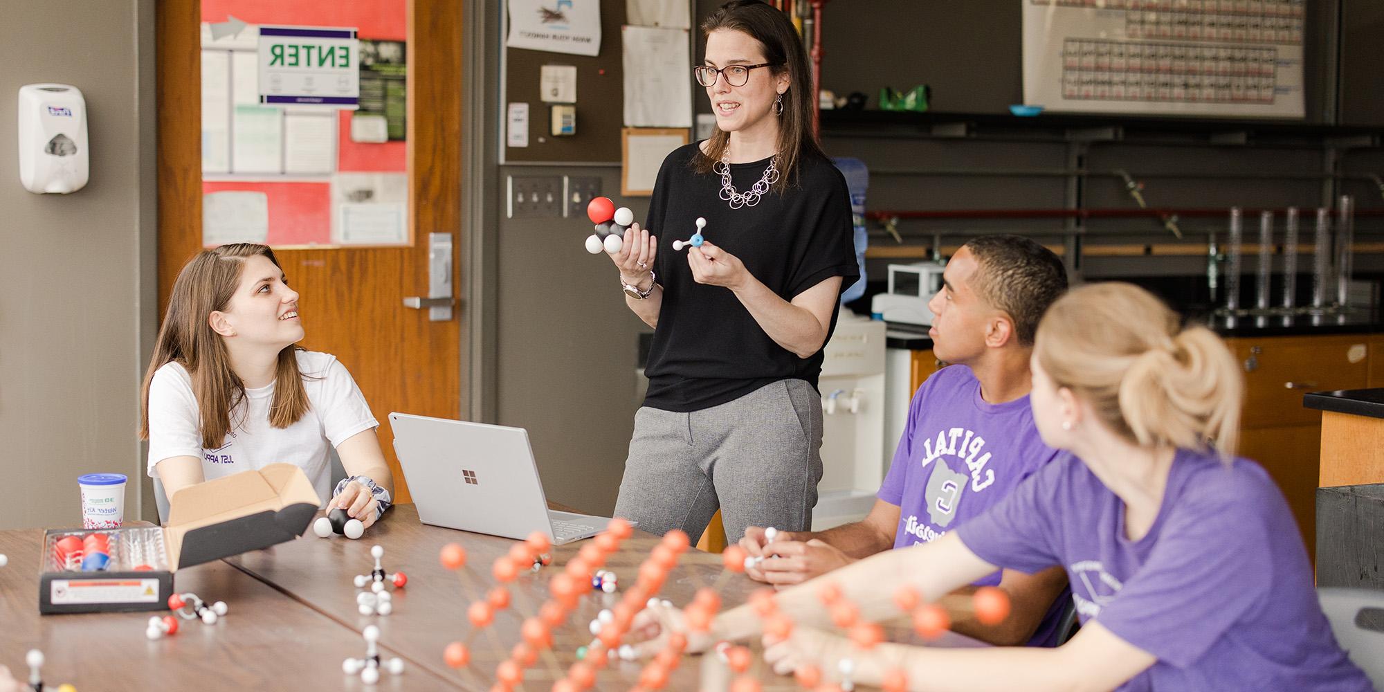 Teacher And Students In Chemistry Class